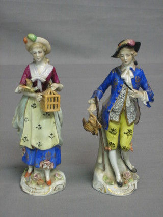 A  pair of 19th/20th Continental porcelain figures in the form of a gentleman with pheasant and lady with bird cage, the base with crowned S mark (some chips to fingers) 6 1/2"