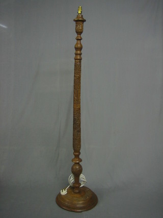 A carved Kashmiri hardwood standard lamp