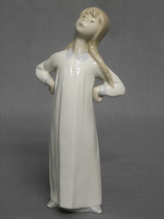 A Lladro figure of a standing girl in night gown 7 1/2"