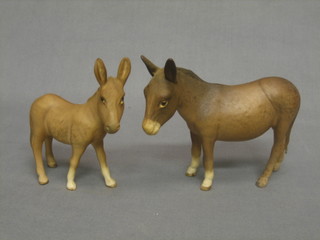 A Beswick matt finished figure of a standing donkey 5" and a donkey foal 4"