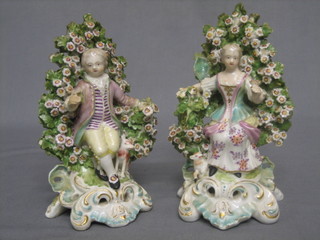 A pair of 19th Century Continental porcelain arbour figures in the form of a seated lady and gentleman (some restoration and chips) 6 1/2"