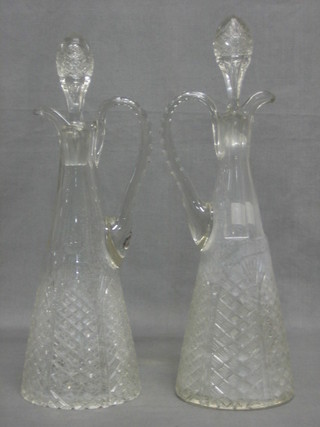 A pair of waisted cut glass ewers and stoppers
