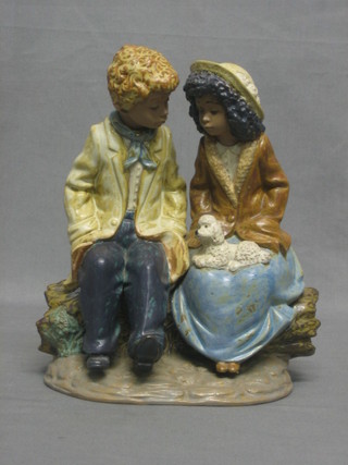 A Nao figure in the form of a seated boy and girl with dog 9" 