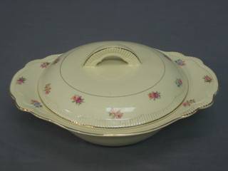 A Clarice Cliff circular twin handled cream glazed tureen and cover with floral decoration 10"