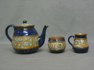 A 3 piece Royal Doulton salt glazed tea service with teapot, milk jug and sugar bowl, bases incised 124Y