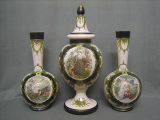 A garniture of opaque pink glass comprising an urn and cover 20" and a pair of club shaped vases 14", decorated scenes of guardian angels