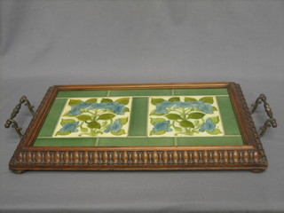 An Edwardian Art Nouveau twin handled tea tray inset 4 tiles