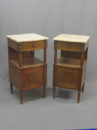 A pair of 19th Century French inlaid mahogany bedside cabinets with pink veined marble tops, each fitted a drawer above a recess with cupboard enclosed by panelled doors, raised on turned supports 16"