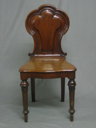 A Victorian mahogany hall chair with solid seat and back raised on turned and fluted supports