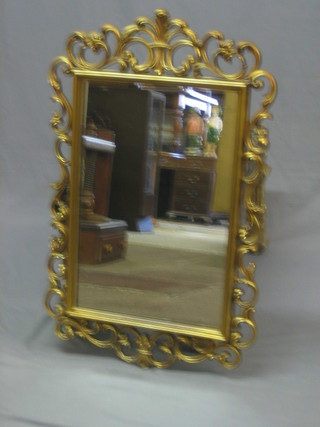 A rectangular plate wall mirror contained in a decorative gilt frame 36"