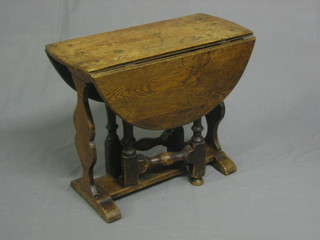 An 18th Century style oval oak drop flap gateleg tea table, raised on turned and block supports 24"