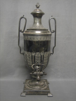 A 19th Century Britannia metal twin handled tea urn raised on a square base 21"