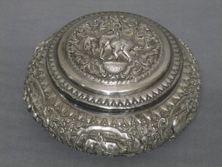 A circular Eastern embossed silver jar and cover decorated elephants 11 ozs