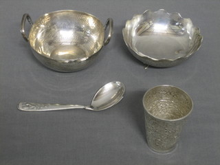 An Eastern embossed silver spirit measure 2 1/2", an Eastern planished silver twin handled dish 3", 1 other dish and a spoon