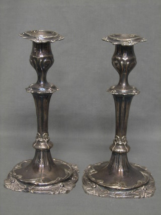 A pair of 19th Century silver plated candlesticks, body with cast leaf decoration and detachable sconces 9 1/2"