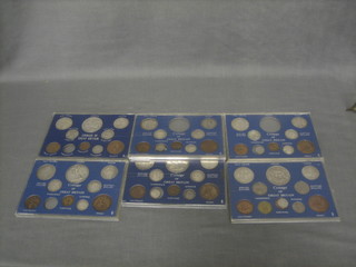 An 1890 crown, an 1896 crown, a 1935 crown, a 1937 crown and other various coins contained within 6 perspex cases