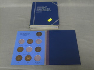 A collection of various British copper coins contained in 6 blue card folders (incomplete)