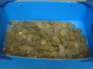 A blue plastic box containing a collection of various coins