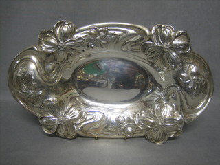 An oval embossed Continental silver dish the base marked Sterling 15 ozs
