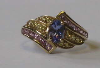 A 9ct gold dress ring set an oval blue stone and pink stones