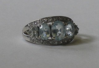 A 9ct white gold dress ring set 3 oval Topaz and small diamonds