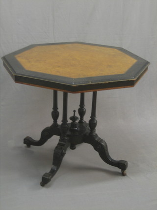 A Victorian octagonal walnut and ebonised centre table, raised on 4 turned columns ending in splayed feet 33"