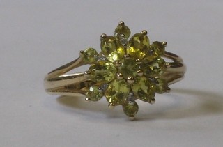 A lady's 9ct gold floral cluster dress ring set green stones