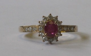 A lady's gold dress ring set an oval cut ruby supported by diamonds