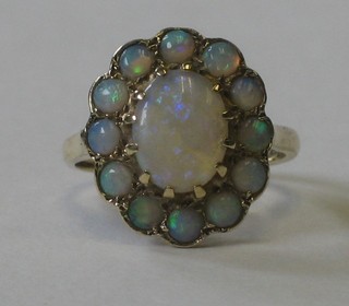 A lady's gold floral design dress ring set opals