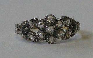 An 18ct yellow gold dress ring in the form of a flower head set diamonds