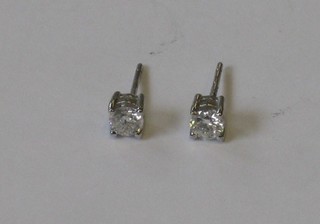 A pair of circular diamond claw set ear studs approx 0.65ct