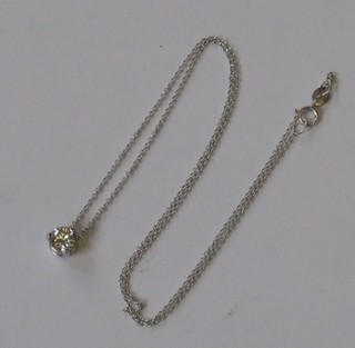 A circular diamond pendant approx. 0.60ct  hung on a white gold chain