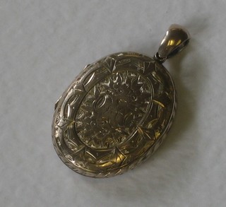 A Victorian engraved oval gilt metal locket