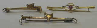 2 gilt metal stock pins in the form of riding crops with foxes masks together with an Edwardian 9ct gold bar brooch set amethyst and demi-pearls