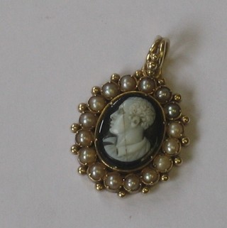 A handsome 19th Century gilt metal pendant set a carved portrait bust on a gentleman contained in a demi-pearl surround