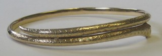 A 9ct gold bangle in the form of a serpent