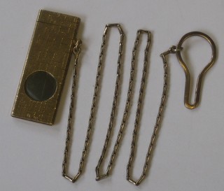 A 9ct gold cigar cutter with engine turned decoration hung on a fine chain