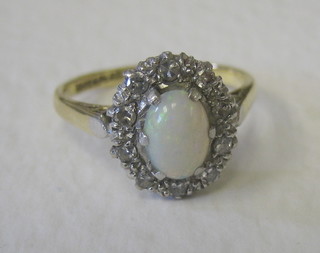 A gold dress ring set an oval cut opal surrounded by diamonds
