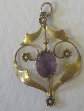 An Edwardian 9ct gold pendant set an oval cut amethyst