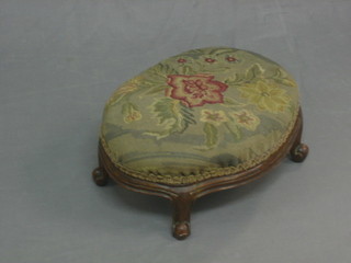 A Victorian oval carved footstool raised on cabriole supports 13"