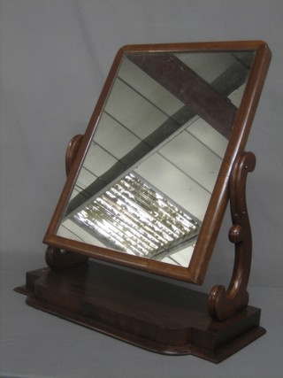 A Victorian rectangular plate dressing table mirror contained in a mahogany swing frame 26"