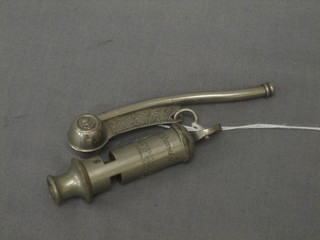 A Bosun's whistle together with a Metropolitan Police whistle