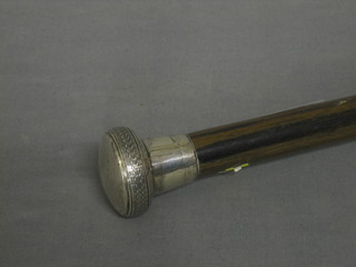 A hardwood cane with silver knob
