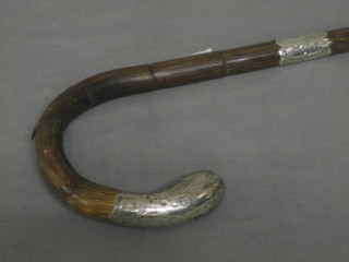 A bamboo finished walking stick with silver mounts
