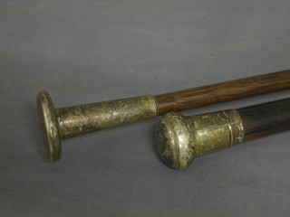 An ebonised evening cane with silver knob together with an umbrella with silver knob
