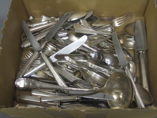 A silver plated ladle and a collection of various flatware