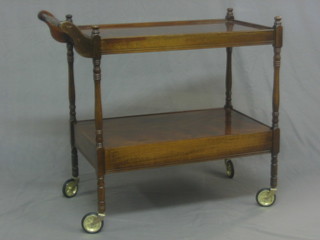 A rectangular mahogany 2 tier drinks trolley 34"