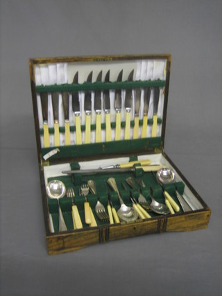 A canteen of silver plated flatware contained in an oak canteen box