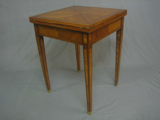 A 19th/20th Century square French Kingwood envelope card table, raised on square tapering supports 22"
