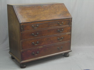 A 19th Century mahogany bureau, the fall front revealing a well fitted interior above 4 long graduated drawers with brass swan neck drop handles, raised on bracket feet 42"